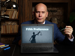 Wall Mural - A handsome businessman showing a laptop with sign Fifth Preference . Close-up shot. Soft focus.