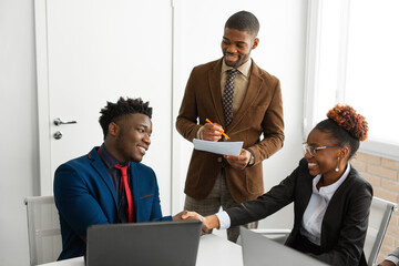 Sticker - team of young african people in the office at the table with a laptop 