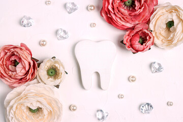 Festive dental background with tooth surrounded by peonies and crystals  on a white background with copy space.