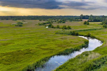 Sticker - Aerial view of green grassland river valley