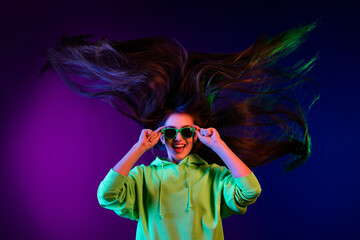 Poster - Photo of nice cool young nice woman long hair blow wind clubber good mood isolated on neon background