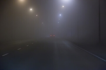 Poster - Car fog on road lit by lamps