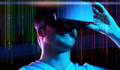 Wall Mural - 3d technology, virtual reality, entertainment and people concept - young man in vr glasses playing game over ultra violet neon lights and binary code on dark background