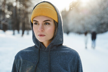 Wall Mural - Young athletic woman wearing sportswear ready for a winter workout