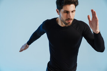 Wall Mural - Young athletic sportsman doing exercise while working out