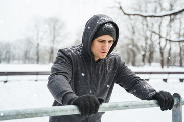 Wall Mural - Athletic man doing push ups during his calisthenics winter workout