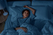 people, bedtime and rest concept - sleepless african american woman lying in bed at night
