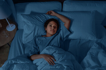 Sticker - people, bedtime and rest concept - sleepless african american woman lying in bed at night