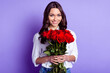 © deagreez - Photo of romantic lady hold bunch flowers shiny toothy smile wear white shirt isolated violet color background