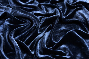 Wall Mural - Luxurious waves of dark blue velvet fabric background.