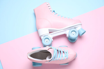 Wall Mural - pair of stylish quad roller skates on color background, flat lay