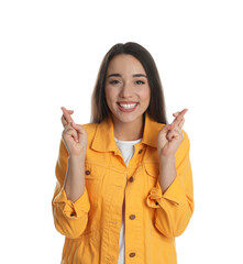 Sticker - Excited young woman holding fingers crossed on white background. Superstition for good luck