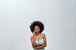 © Svitlana - Excited voluptuous young woman with afro hair style wearing blue underwear smiling at camera, posing isolated over light background