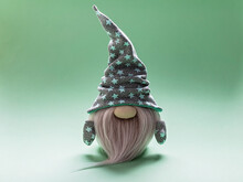 Cute Bearded Gnome In A Cap With Stars On A Light Green Background. Handmade Soft Toy. Home Decor