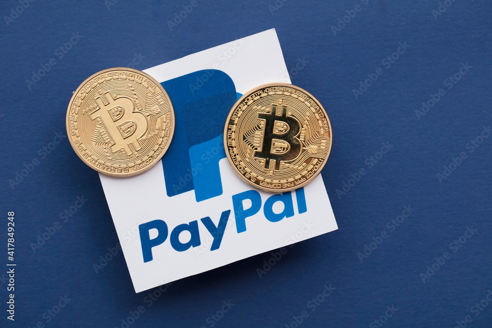 LONDON, UK - March 2021: Bitcoin cryptocurrency on a paypal online payment logo