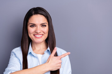 Sticker - Photo of charming sweet mature woman wear formal shirt smiling pointing finger empty space isolated grey color background