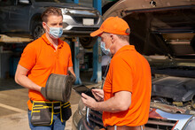 Mechanics Checking Maintainance A Pickup Truck By Replace Air Filter In Car Service Garage