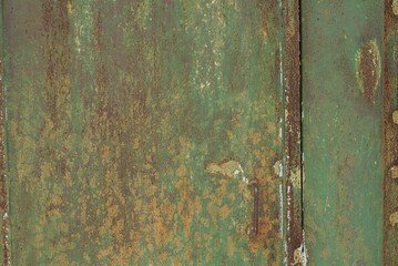 Wall Mural - green metal  texture from an old iron wall with a brown rusty seam