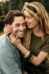 Loving young couple hugging and smiling together on nature background