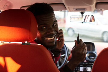 Happy African American in the car, buying, renting