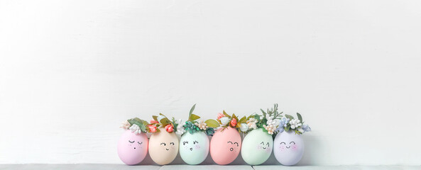 Wall Mural - decorative easter eggs on a light wooden background. Easter-themed background with place for text