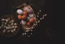 Vintage Background With Easter Eggs In Basket On Dark Background. Easter Background With Eggs And Spring Flowers. Top View With Copy Space.