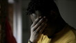 © Marco - African man standing by window thinking about life. Concerned worried emotion