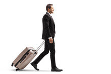 Full Length Profile Shot Of A Young Businessman In A Suit Walking And Carrying A Suitcase