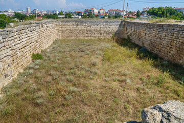 Wall Mural - Remains of urban water reservoir in Chersonesus Tauric, ancient city founded by Greeks. Modern city Sevastopol (Crimea) is on background