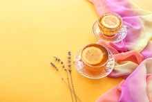 Two Teacups With Lemon Slices, Lavender Branches On A Yellow Background, Space For Text