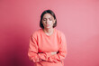 © Анастасия Каргаполов - Woman wearing casual sweater on background suffering stomach ache with painful grimace, feeling sudden period cramps, gynecology concept