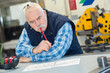 senior male worker looking at paperwork