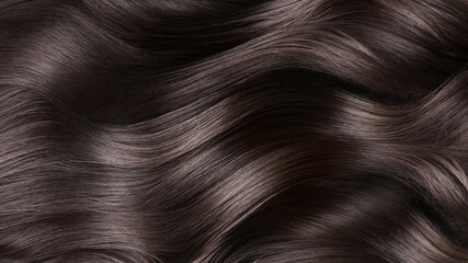 a closeup view of a bunch of shiny curls brown hair