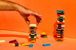 © VISTA by Westend61 - Man stacking toy blocks against orange background