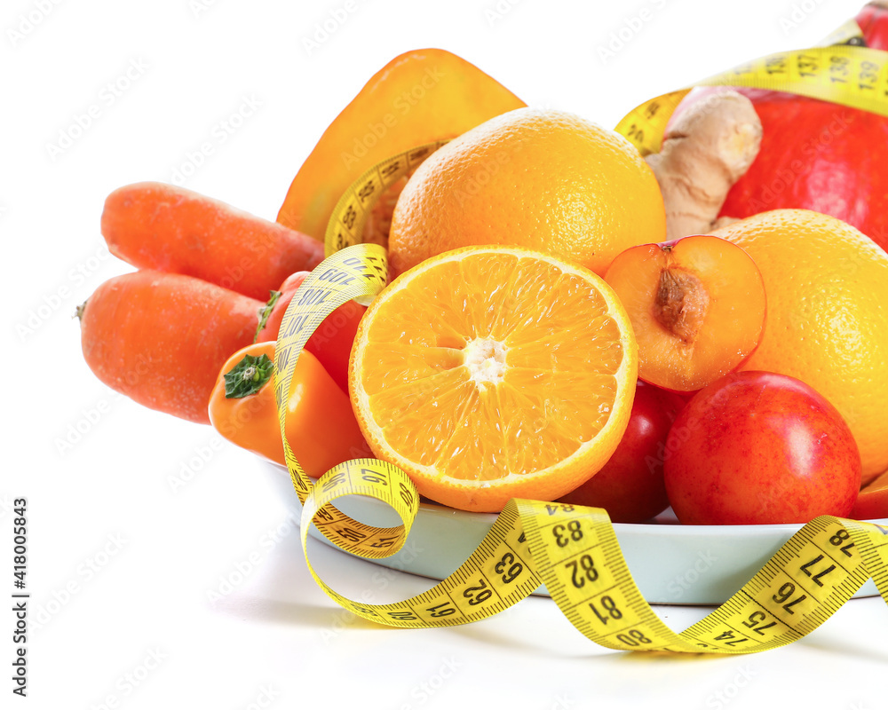 Plate with healthy products and measuring tape on white background
