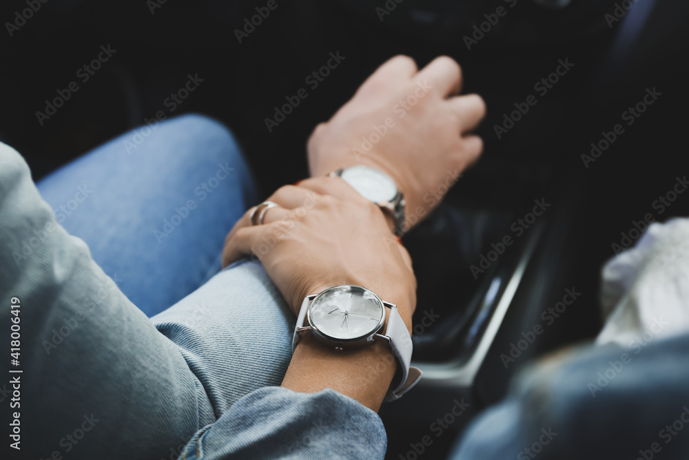 Young couple holding hands in car