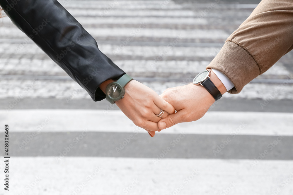 Young couple holding hands outdoors