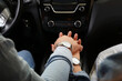 © Pixel-Shot - Young couple holding hands in car