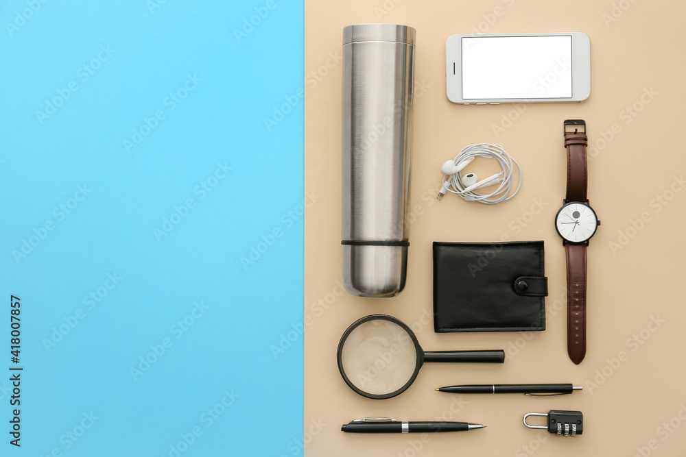 Modern thermos and items for travel on color background