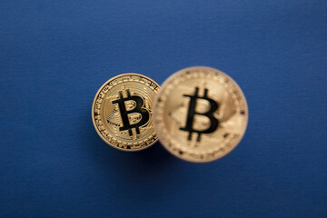 Bitcoin cryptocurrency blockchain gold coins on a blue background