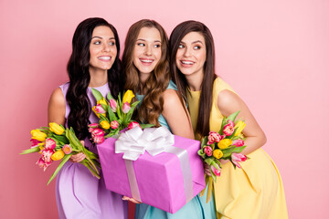 Poster - Photo of optimistic nice long hairdo ladies hold flowers gift look empty space wear pastel dress isolated on pink color background