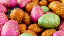 Multicolored, Foil Wrapped Easter Egg Background. Beautiful Easter Wallpaper With, Patterned Pink, Green And Orange Eggs. 3D Render 