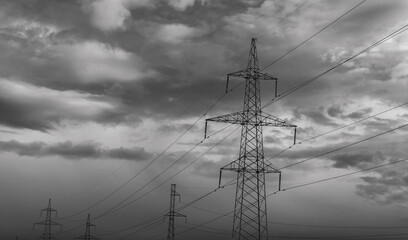  high-voltage  power lines at storm clouds.