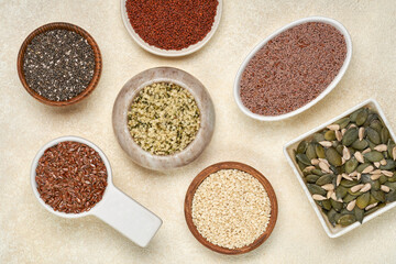 Wall Mural - Various healthy seeds in bowls- flaxseed, sesame, pumpkin , sunflower, psyllium, hemp, cress. Top view, flat lay