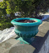 large green flowerpot in the park in early spring