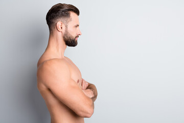 Profile side photo of young handsome man confident serious look empty space crossed hands naked isolated over grey color background