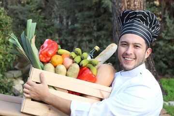 Chef holding healthy grocery wooden box 