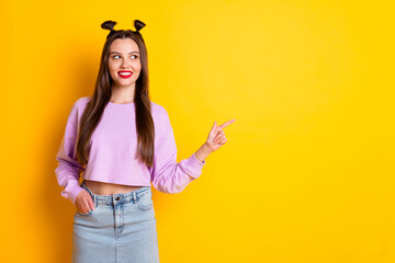 Sticker - Photo of optimistic nice brunette girl point empty space wear pink sweater isolated on bright yellow color background