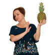 woman turned away from pineapple, dressed in blue dress, on isolated background