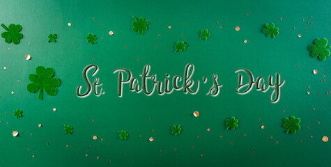 Wall Mural - Happy St. Patricks Day decoration concept. Flat lay, top view of clover leaves on green background
